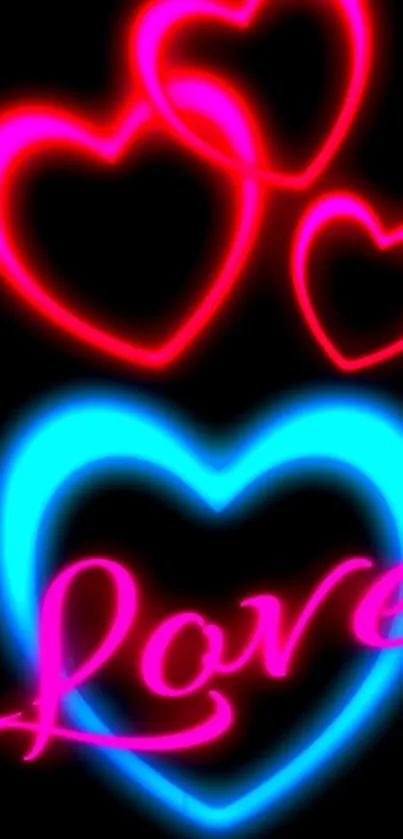 Neon love hearts and the word love in glowing colors on black background.