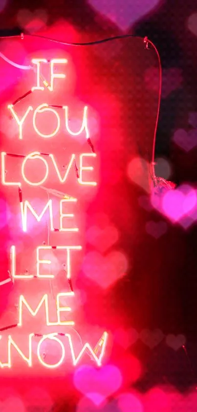 Neon sign with love quote glowing on a vibrant pink background.