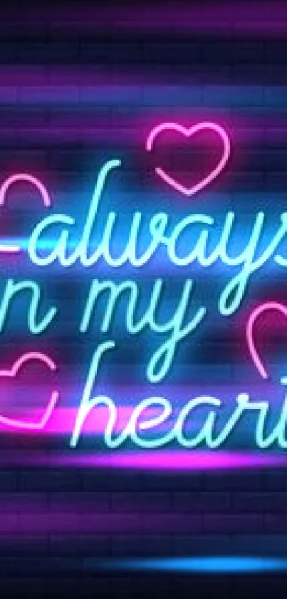 Neon 'Always in My Heart' text with pink hearts on a dark brick wall.