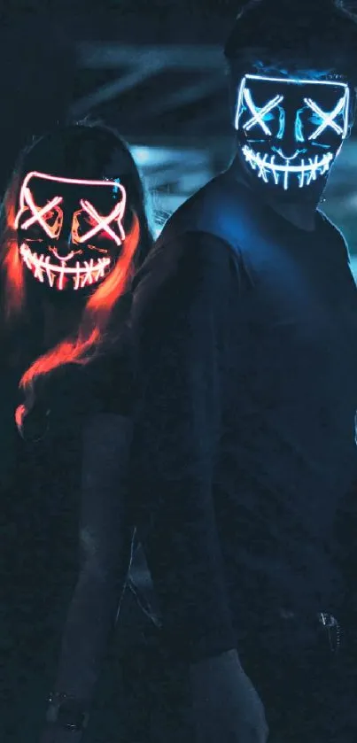 Two people in glowing neon masks in a dark setting.