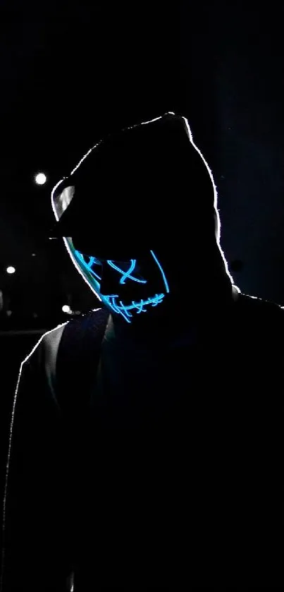 Mysterious figure with a neon mask in the dark.