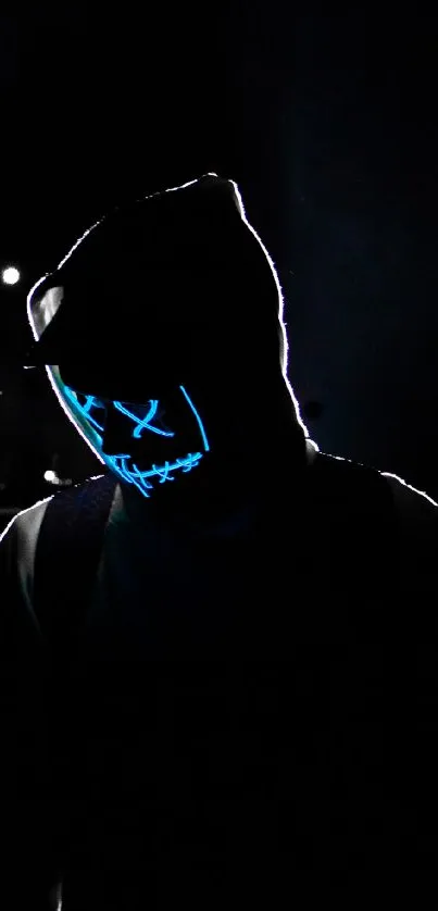 Mysterious figure wearing a glowing neon mask in the dark.