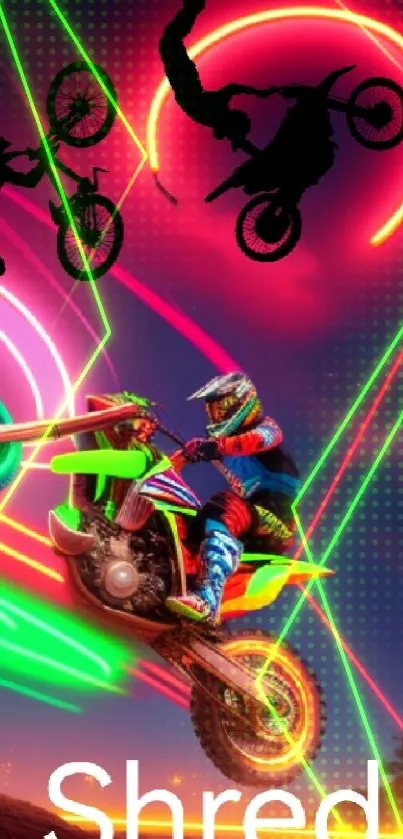 Neon motocross rider performs stunts under bright, colorful lights.