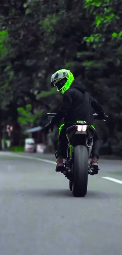 Motorcyclist in neon helmet on forest road wallpaper.