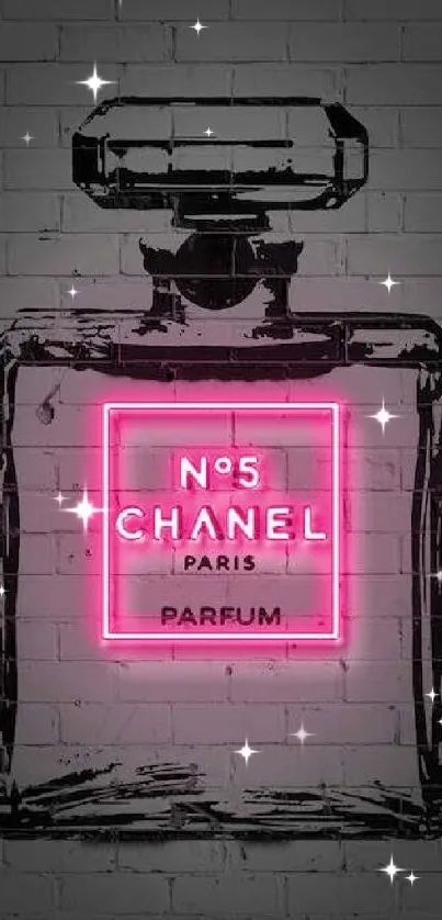 Neon pink Chanel perfume bottle on a brick wall.