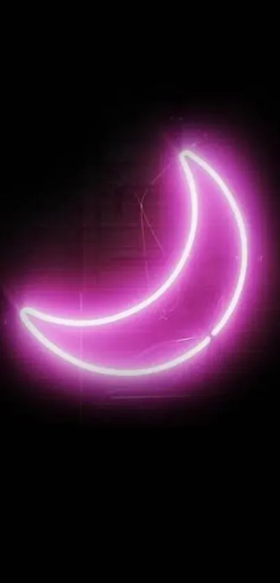 Neon pink crescent moon glowing in darkness.