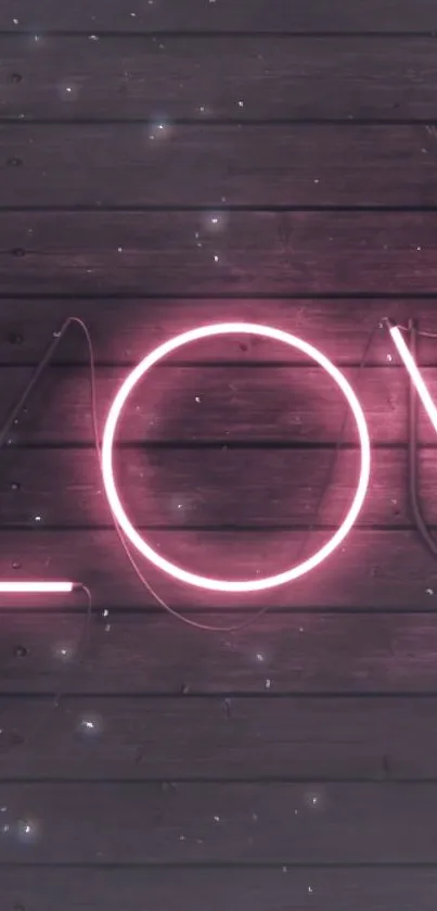 Neon pink 'LOVE' sign on wooden background wallpaper.