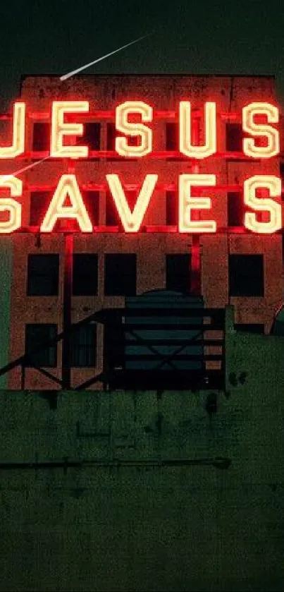 Neon 'Jesus Saves' sign on city building at night.