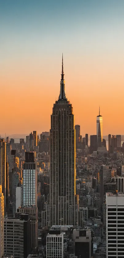 New York City skyline at sunset with vibrant orange sky.