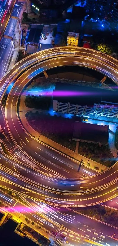 Aerial view of city at night with glowing roads.
