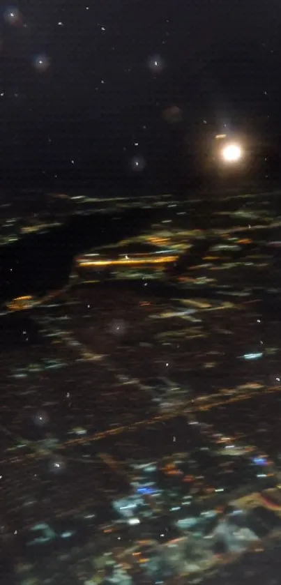 Aerial view of a city at night with glowing lights and a star-filled sky.