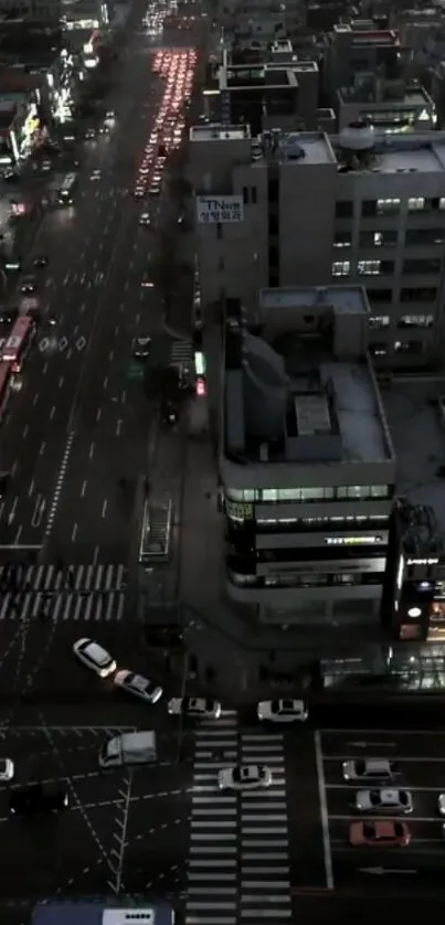 Aerial cityscape view at night with streetlights and traffic.