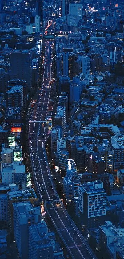 Aerial view of a vibrant city at night with illuminated streets.