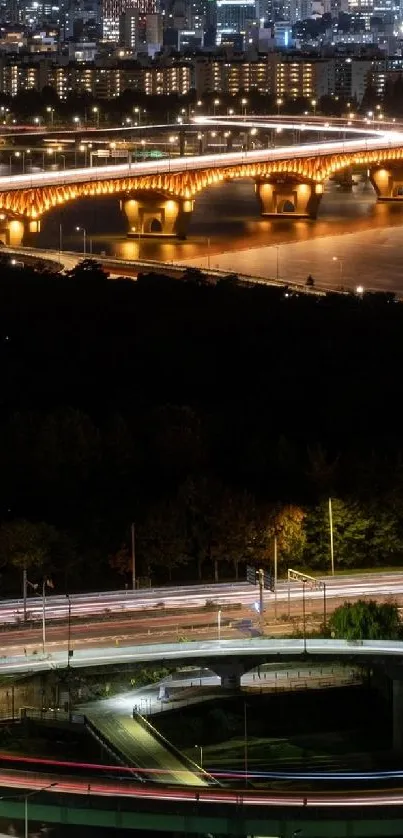 Bridge over water with city lights at night.