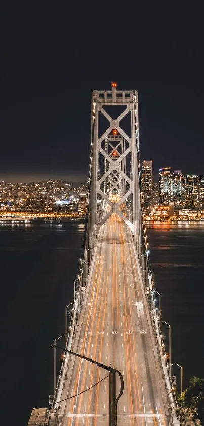 Night view of a bridge with city lights reflecting on the water.