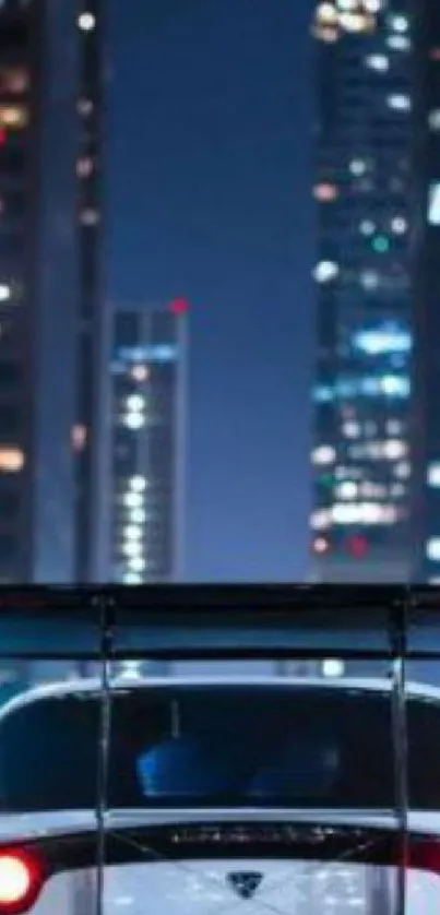 Car driving at night in a city, surrounded by illuminated skyscrapers.