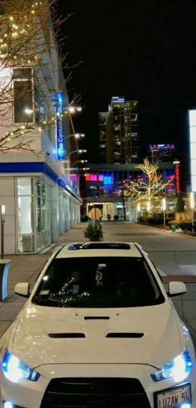 White car in vibrant night cityscape with glowing street lights.