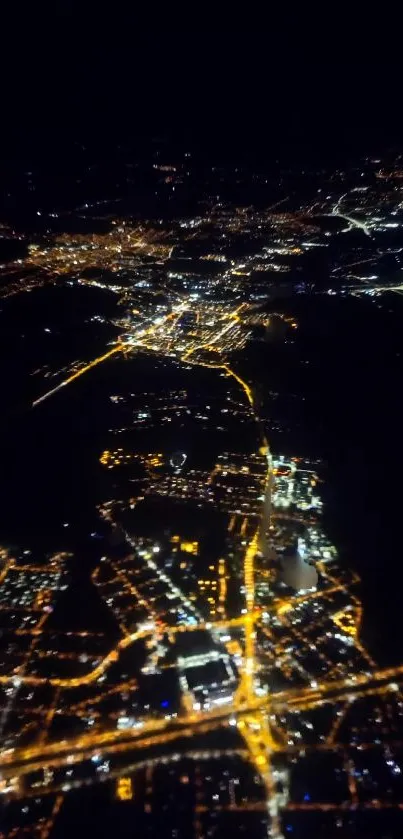 Aerial view of city lights at night from above.