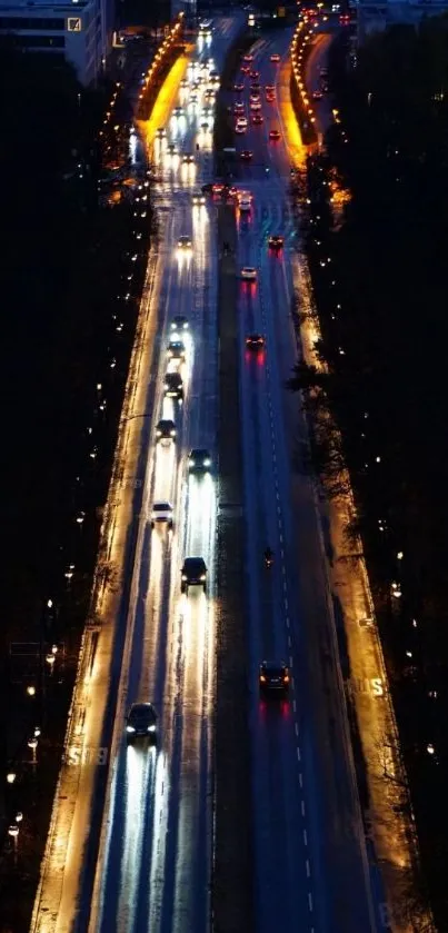 Aerial night view of a city road with vibrant lights.