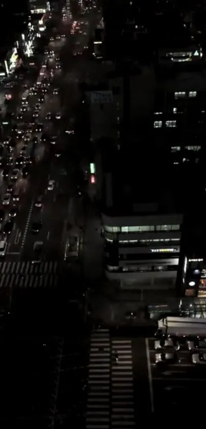 Aerial view of city streets illuminated at night.