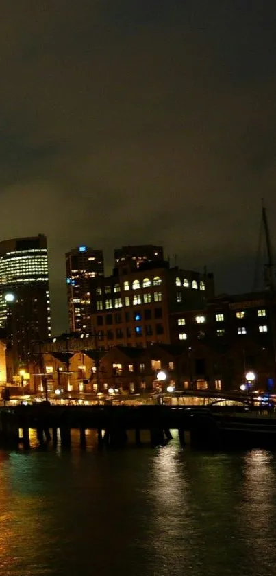 A night city skyline with reflections on water, illuminated by urban lights.