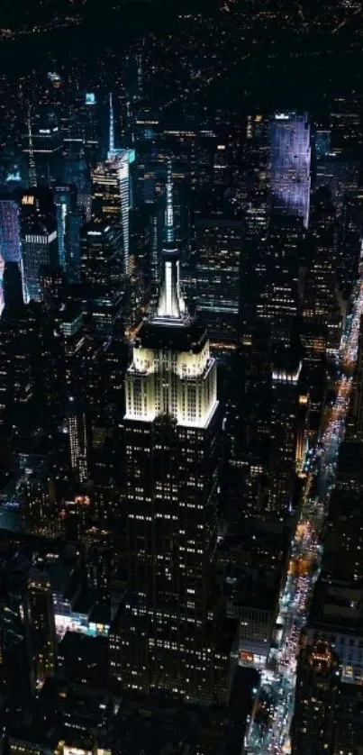 Aerial view of city skyline at night with illuminated skyscrapers.