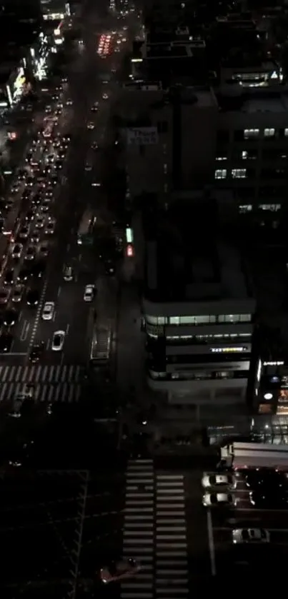 Nighttime city street with traffic and vibrant lights.