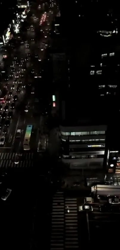 A lively night city view with glowing street lights and traffic from above.