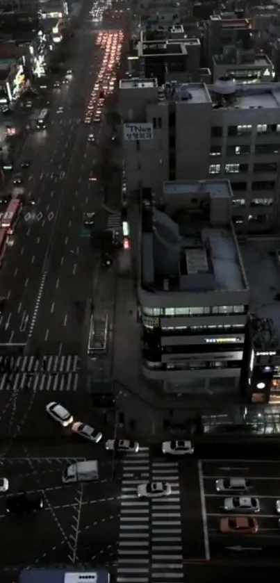 Aerial view of a bustling city street at night with city lights glowing.