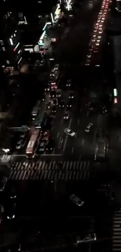 Nighttime city street with vibrant lights and busy traffic.