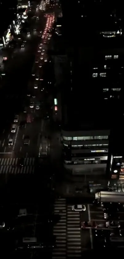 Night view of a busy city street with cars and lights.