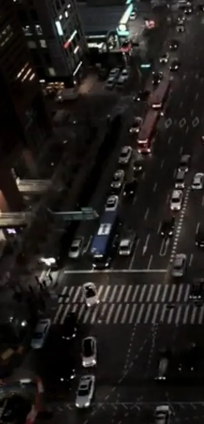 Nighttime view of a busy city street with cars and lights.