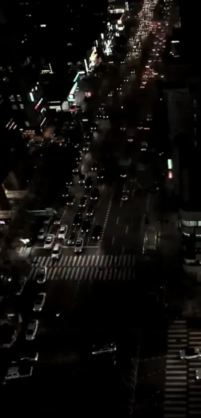 A bustling city street at night with traffic and glowing lights.