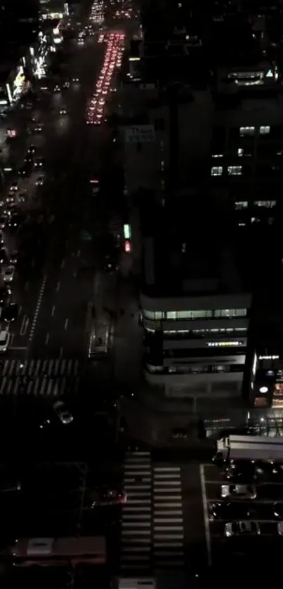 Nighttime city street view with vibrant lights and traffic.