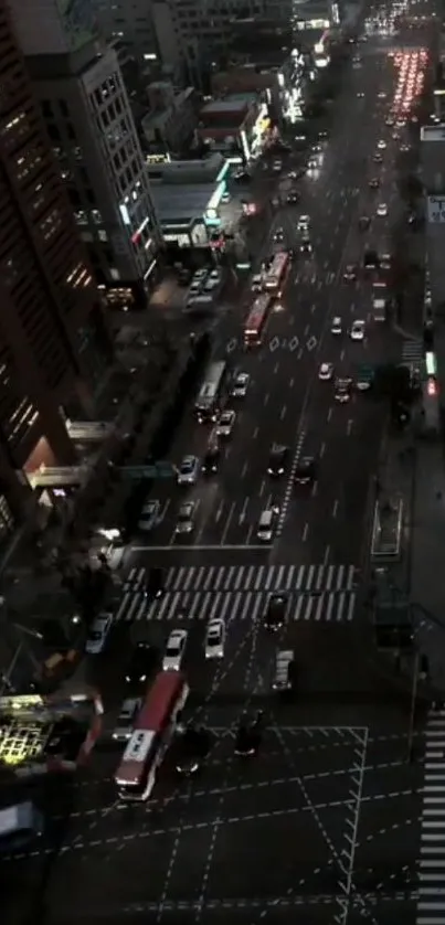 Aerial city view of bustling night street with lights and traffic.