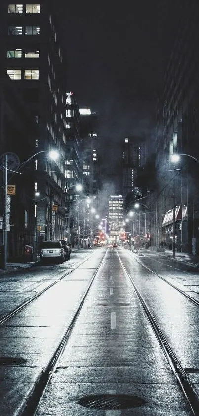 Nighttime city street with lights and wet pavement.