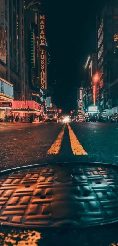 Vibrant street view of a city at night with bright lights and urban atmosphere.