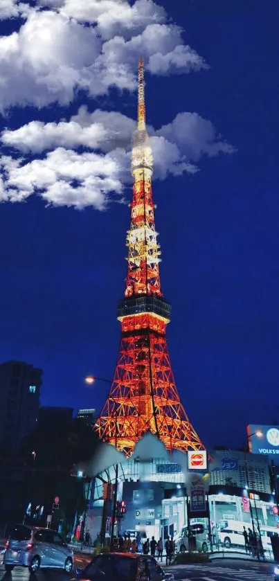 Illuminated city tower at night with a deep blue sky backdrop.