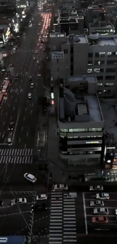 Aerial view of city traffic at night with vibrant street lights.