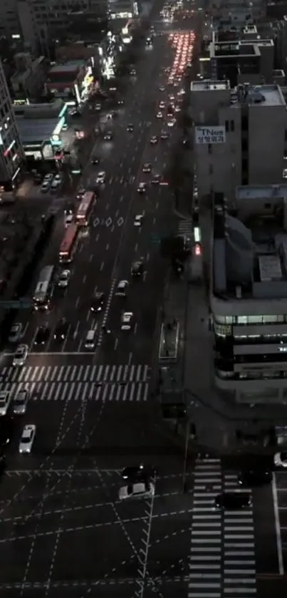 Aerial view of city traffic lights at night, illuminating the bustling urban streets.