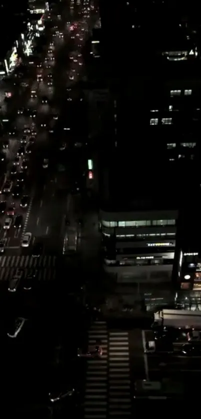 A night view of city traffic from above, showing vibrant city lights.