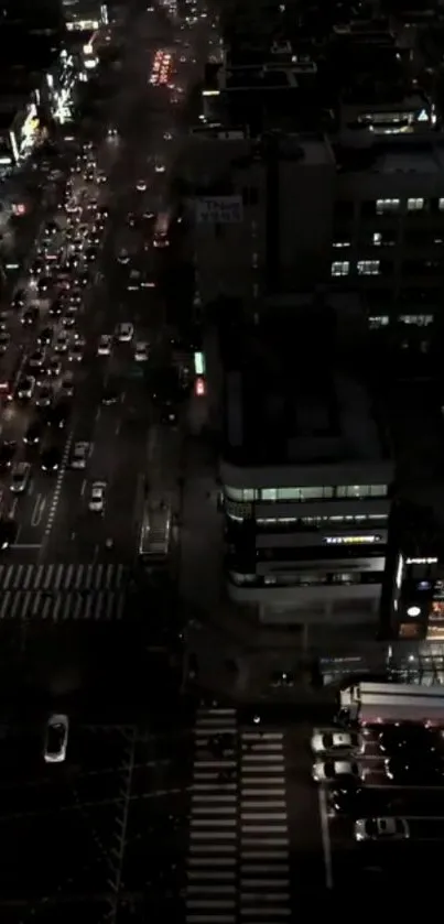 Night view of city traffic with illuminated streets and dark buildings.