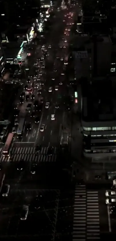 Night view of a bustling city street with vibrant traffic lights.