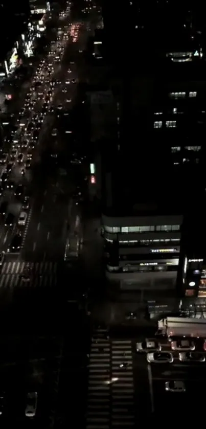 Overhead view of night city traffic with bright streetlights.