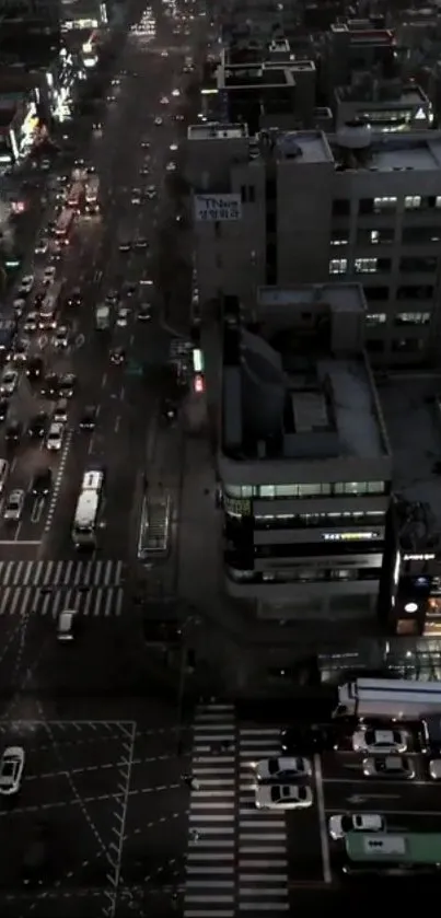 Overhead view of a busy urban street at night with vibrant city lights.