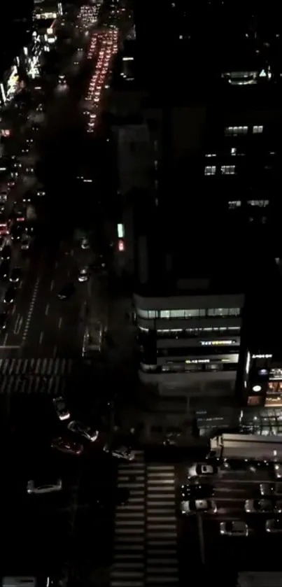 Aerial view of a city street illuminated by night lights.