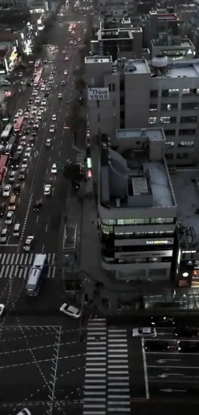 Aerial view of a bustling city at dusk with vibrant streetlights.