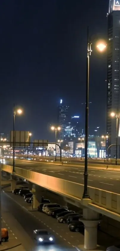 Nighttime cityscape with highway and skyscrapers illuminated by streetlights.