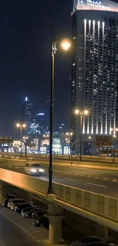 Night cityscape with illuminated highway and buildings.