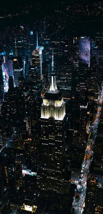 Aerial view of a city skyline brilliantly illuminated at night.